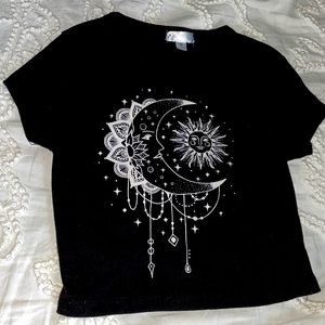This is a black cropped shirt with a sun and moon on it.
